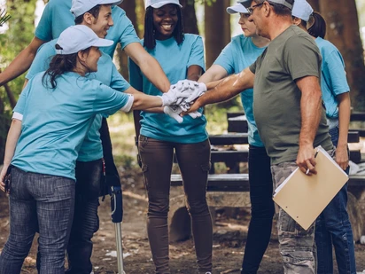 Group of adults cheerfully getting ready to do yard work