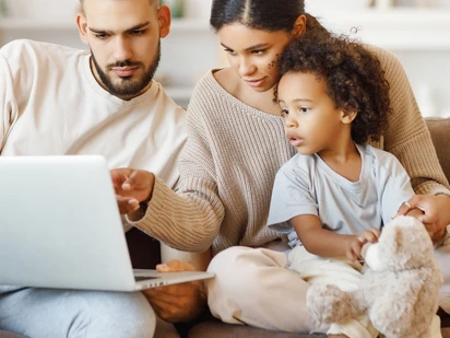 Family looking at a laptop together