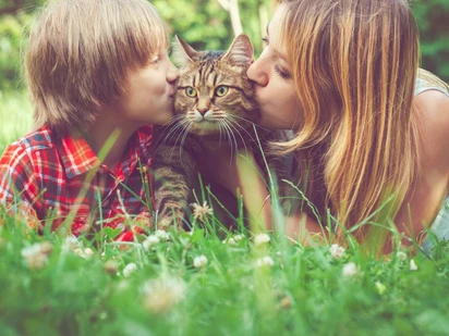 Child and adult with a cat