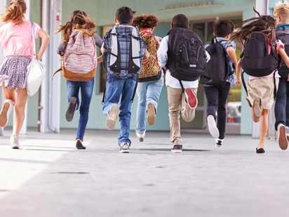 Children running in a school hallway