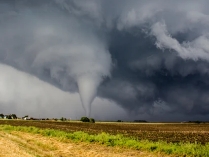 Tornado touches down in a field.