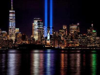 Manhattan skyline with blue lights representing the missing World Trade Center buildings.