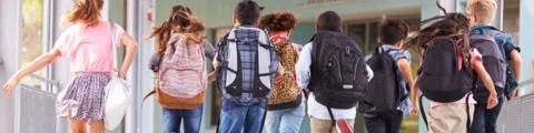 Children running in a school hallway