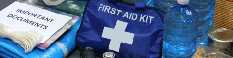 Items from emergency kit, first aid kit, bottles of water, flashlight, batteries.