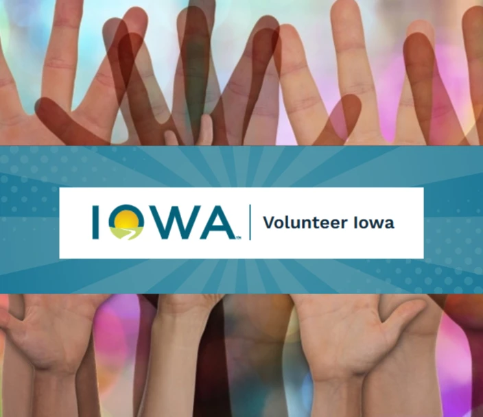 Hands raised to volunteer with Volunteer Iowa logo.