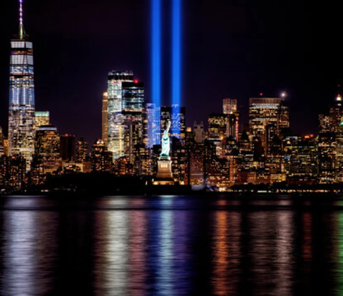 Manhattan skyline with blue lights representing the missing World Trade Center buildings.