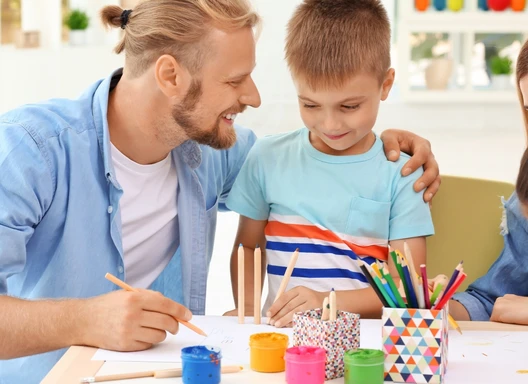 Family with young children gathered at a table with art supplies