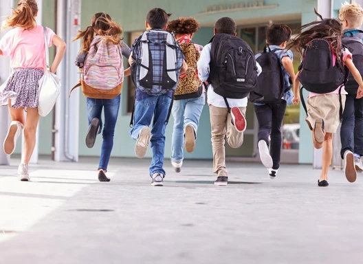 Children running in a school hallway