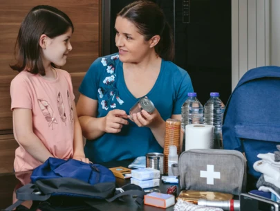 Mom helps daughter build an emergency supply kit.